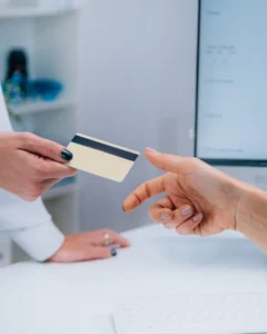 A person is handing over their credit card.