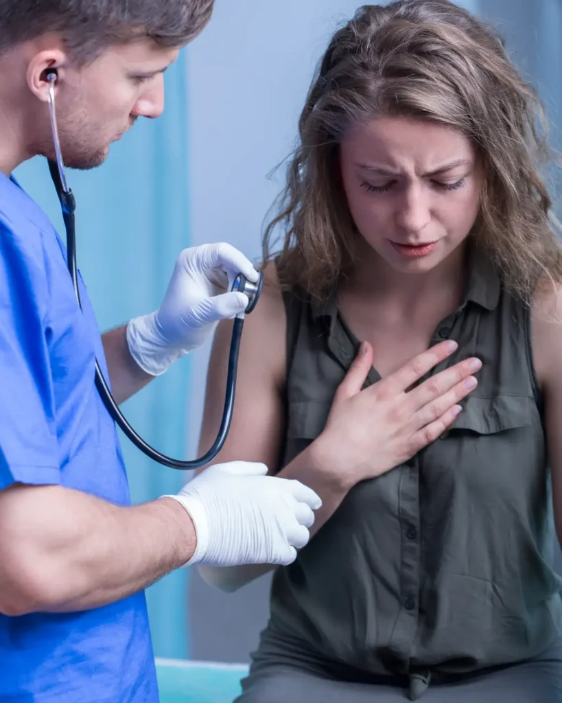 A doctor is sitting at the table and talking to someone.