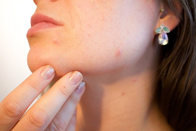 A woman with her hand on the side of her face.