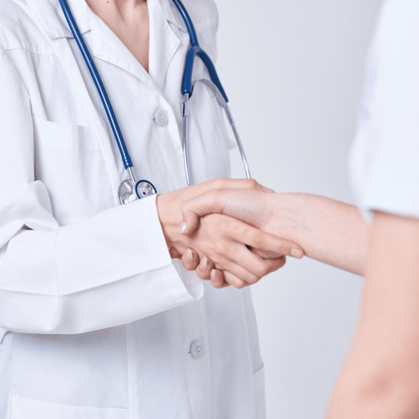 DOC-AID Provider welcome A doctor shaking hands with another person working in urgent care laredo tx