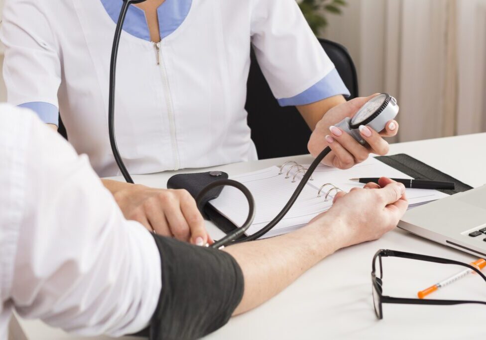 doctor checking the blood pressure of the patient in an urgent care clinic